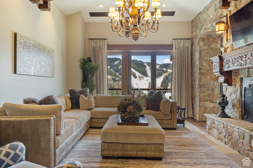 Living room featuring a towering ceiling, hardwood / wood-style floors, and a chandelier