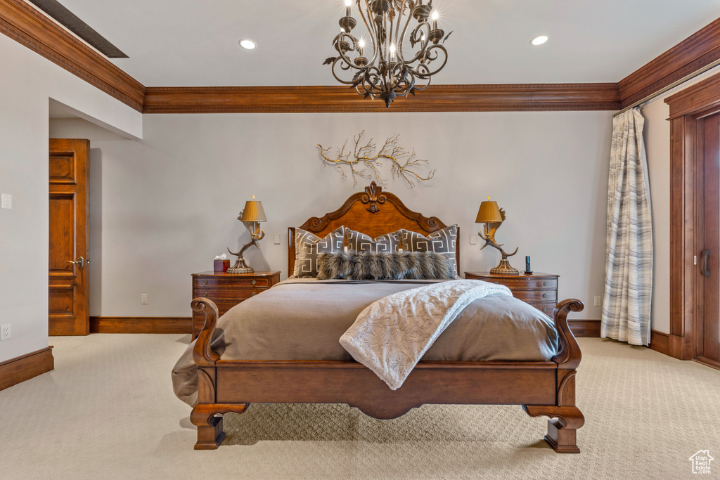 Carpeted bedroom featuring a chandelier and ornamental molding