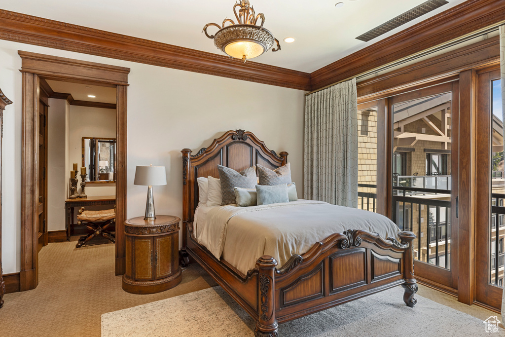 Bedroom with carpet flooring, crown molding, and multiple windows