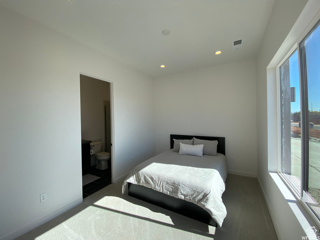 Carpeted bedroom with ensuite bathroom