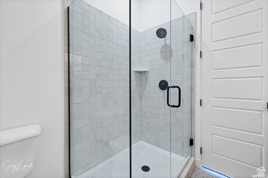 Bathroom featuring walk in shower and toilet