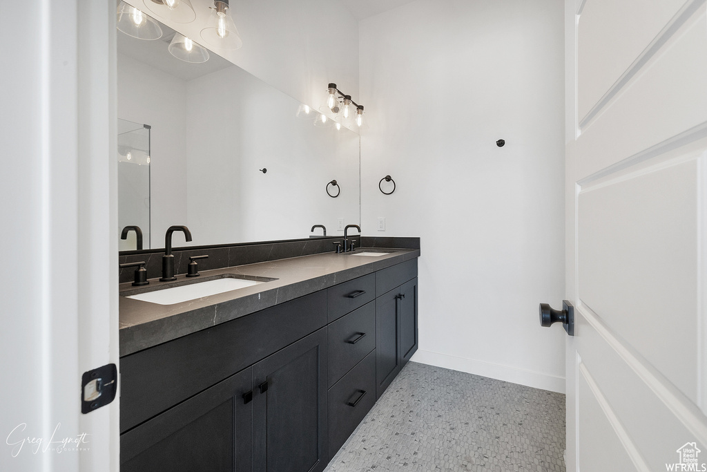 Bathroom with tile floors and double sink vanity