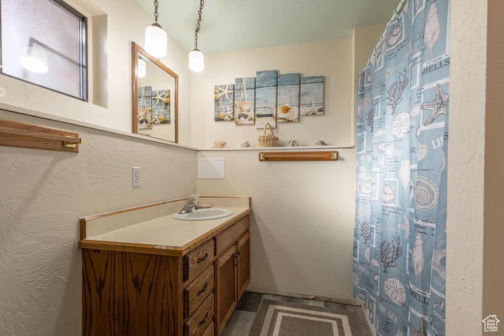 Bathroom with vanity with extensive cabinet space