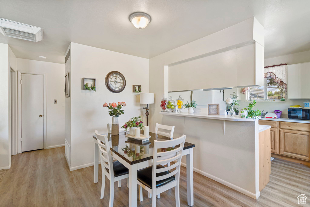 Dining room with light hardwood / wood-style floors