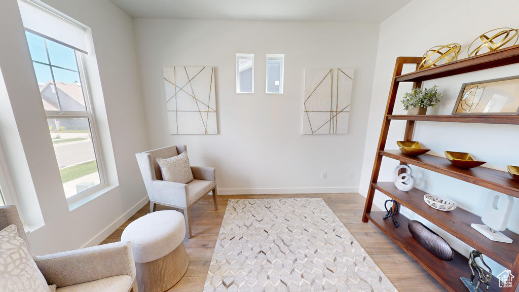 Sitting room with light hardwood / wood-style flooring