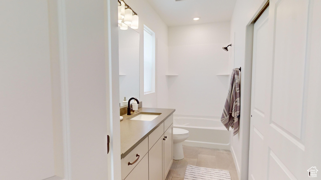 Full bathroom featuring tile flooring, toilet, bathtub / shower combination, and large vanity