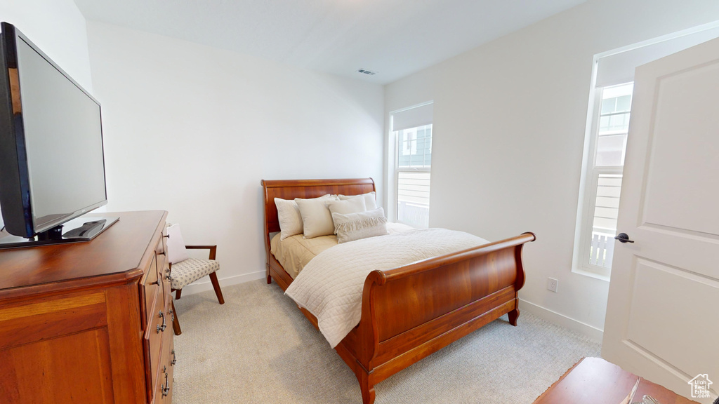 Bedroom featuring light colored carpet