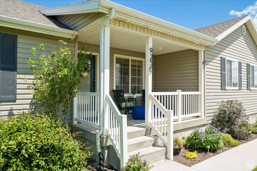 Entrance to property featuring covered porch