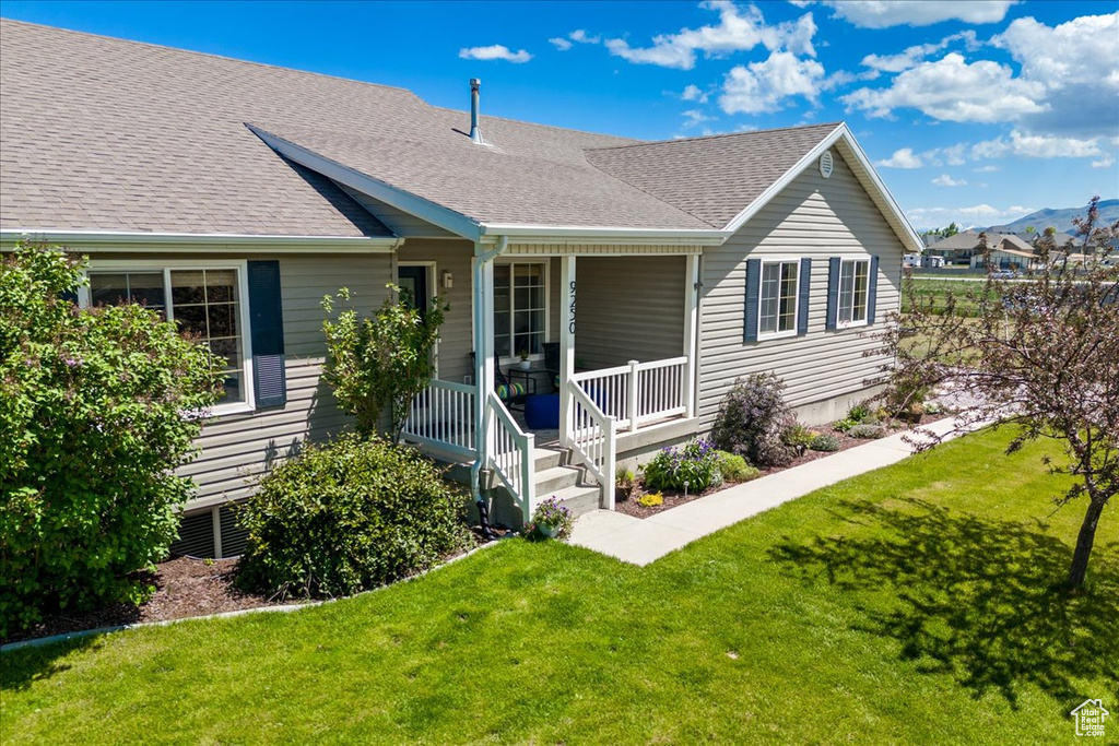 Ranch-style home featuring a front yard and a porch