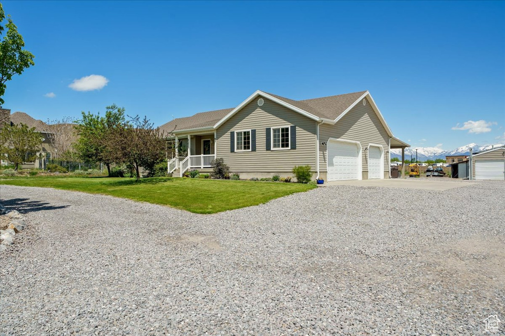 View of front of home featuring a front yard and covered porch