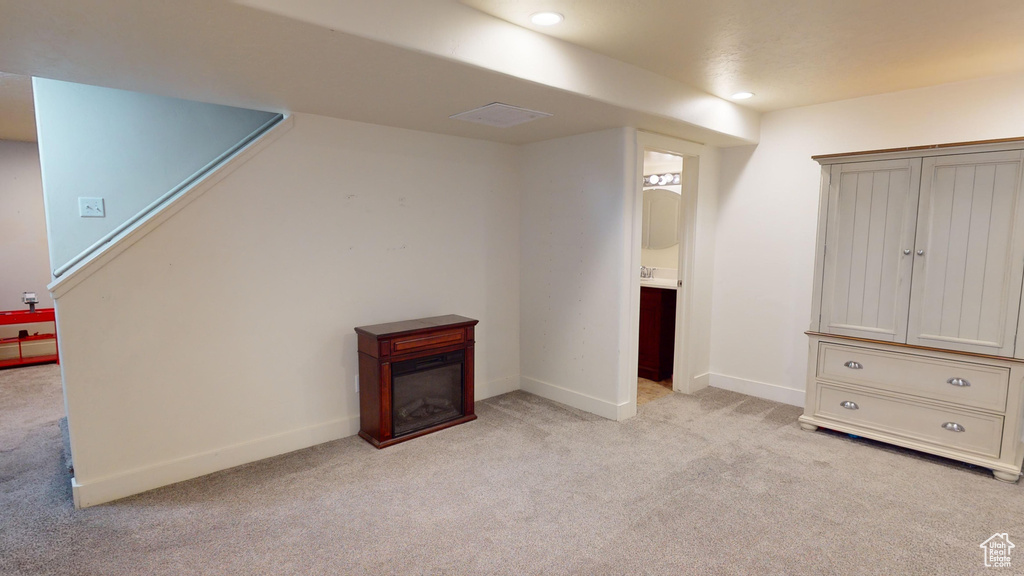 Basement with light colored carpet