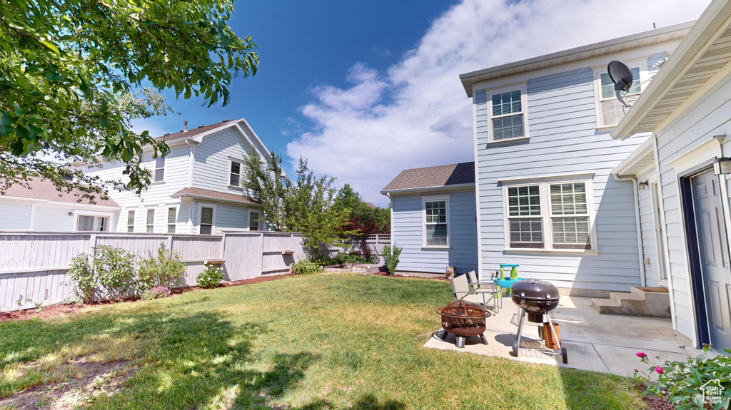 View of yard with a fire pit and a patio