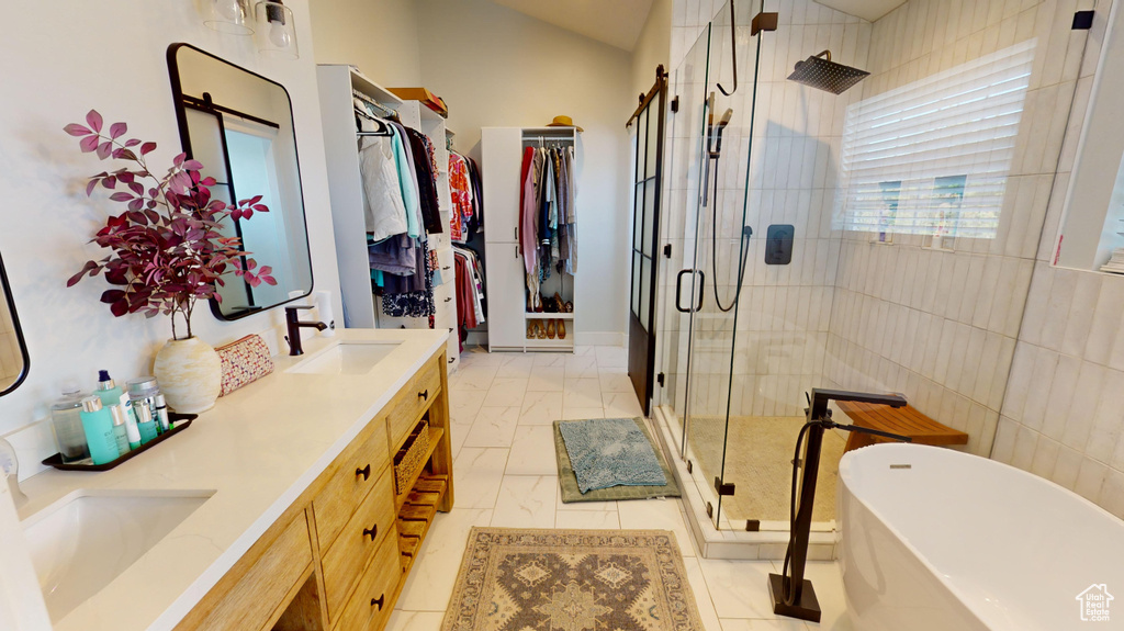 Bathroom featuring dual bowl vanity, tile flooring, and plus walk in shower