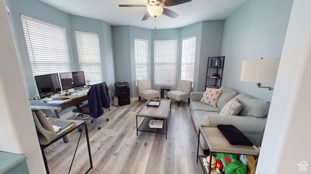 Office area featuring ceiling fan and light wood-type flooring