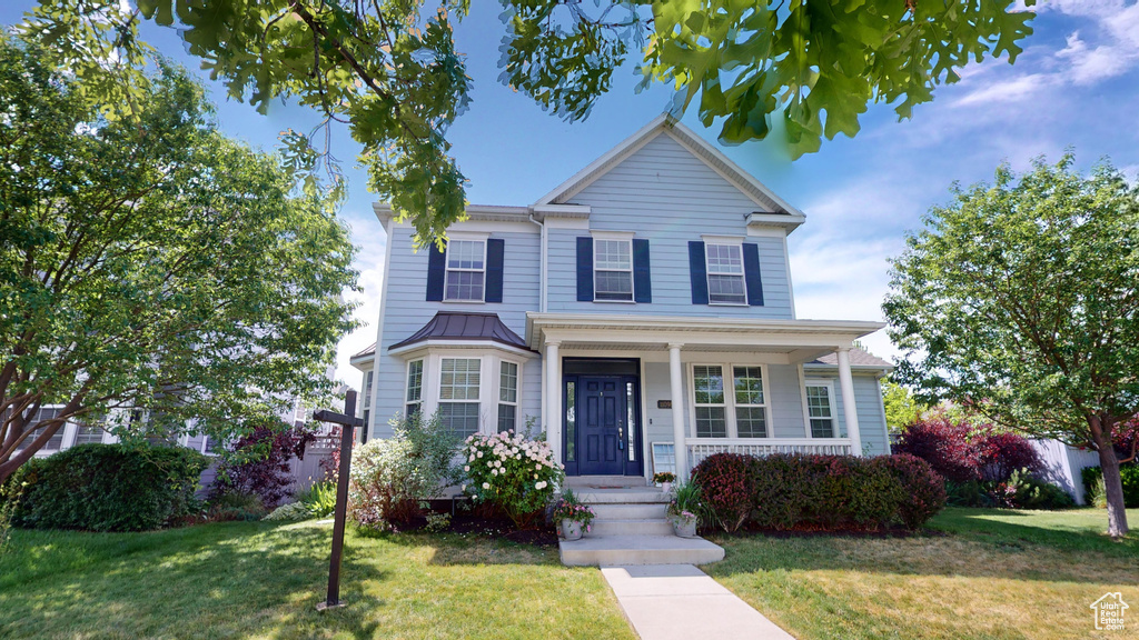 View of front of property with a front yard