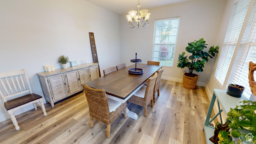 Dining area featuring light hardwood / wood-style floors and an inviting chandelier