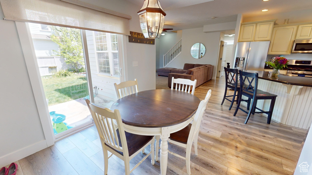 Dining room with a chandelier and light wood-type flooring