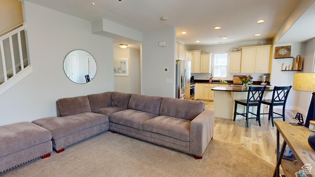 Living room with sink and light wood-type flooring