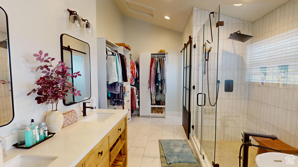 Bathroom with dual vanity, an enclosed shower, and tile floors