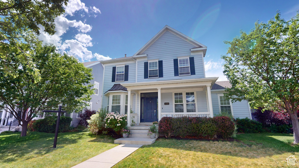 View of property with a front lawn