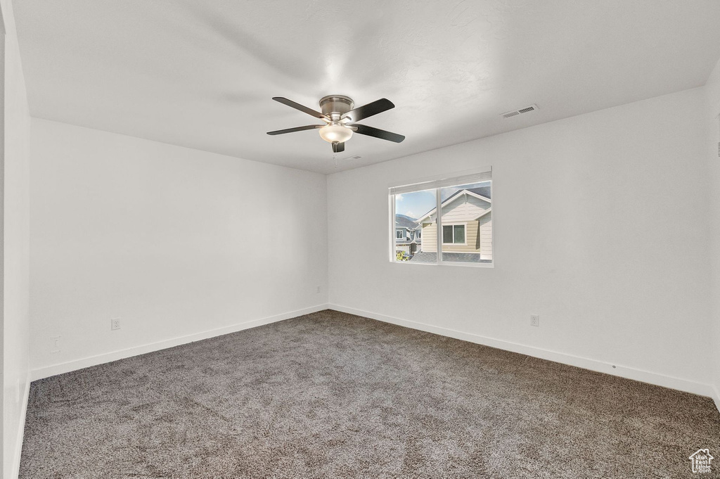 Spare room with carpet and ceiling fan