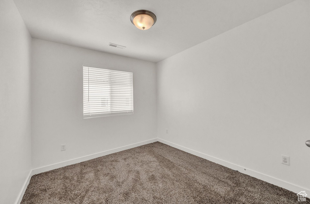 Empty room with carpet flooring