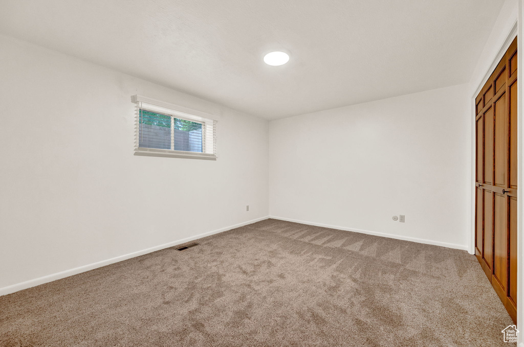 Unfurnished room featuring carpet flooring