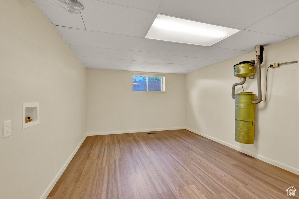 Basement featuring hardwood / wood-style floors and a paneled ceiling