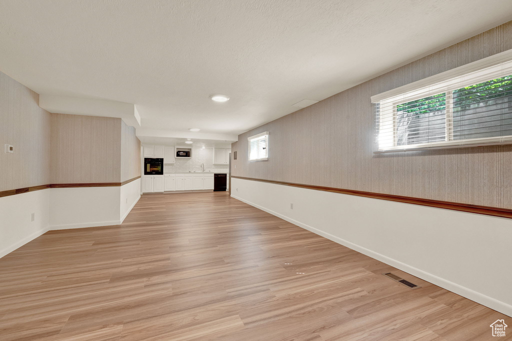 Unfurnished living room with light wood-type flooring