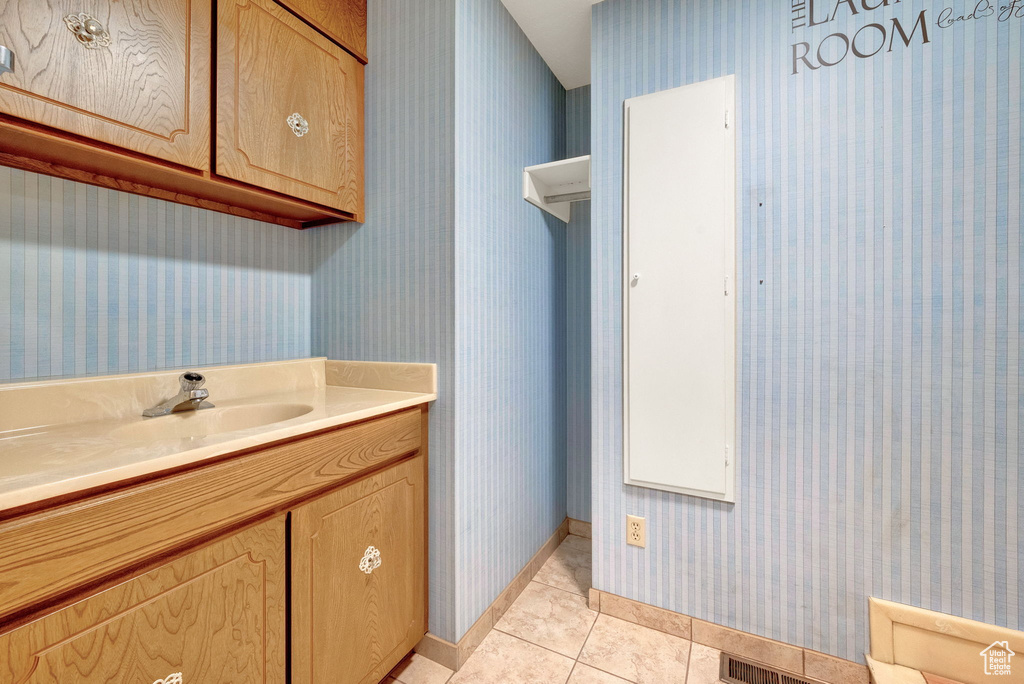 Bathroom featuring tile floors and vanity