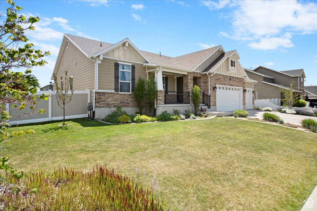 Craftsman-style home with a garage and a front lawn