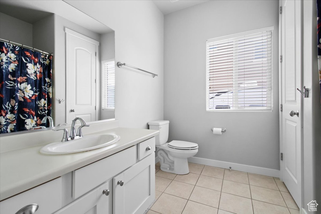 Bathroom with vanity, toilet, and tile floors