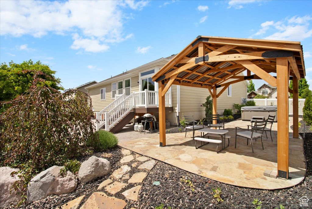 View of patio featuring an outdoor living space and a gazebo