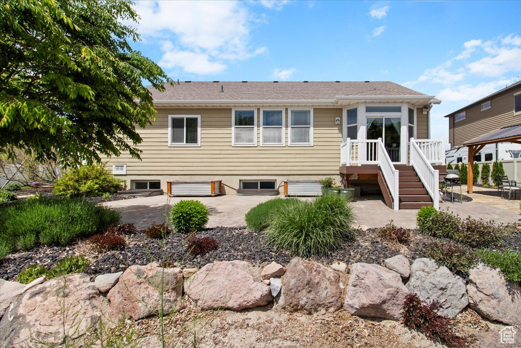 Rear view of house featuring a patio