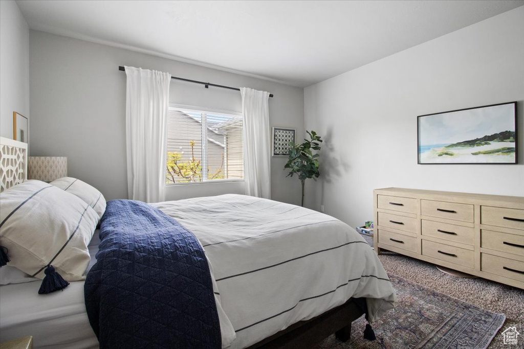 Bedroom with dark colored carpet