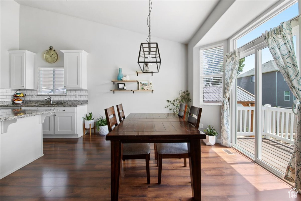 Dining area featuring dark hardwood / wood-style floors and vaulted ceiling