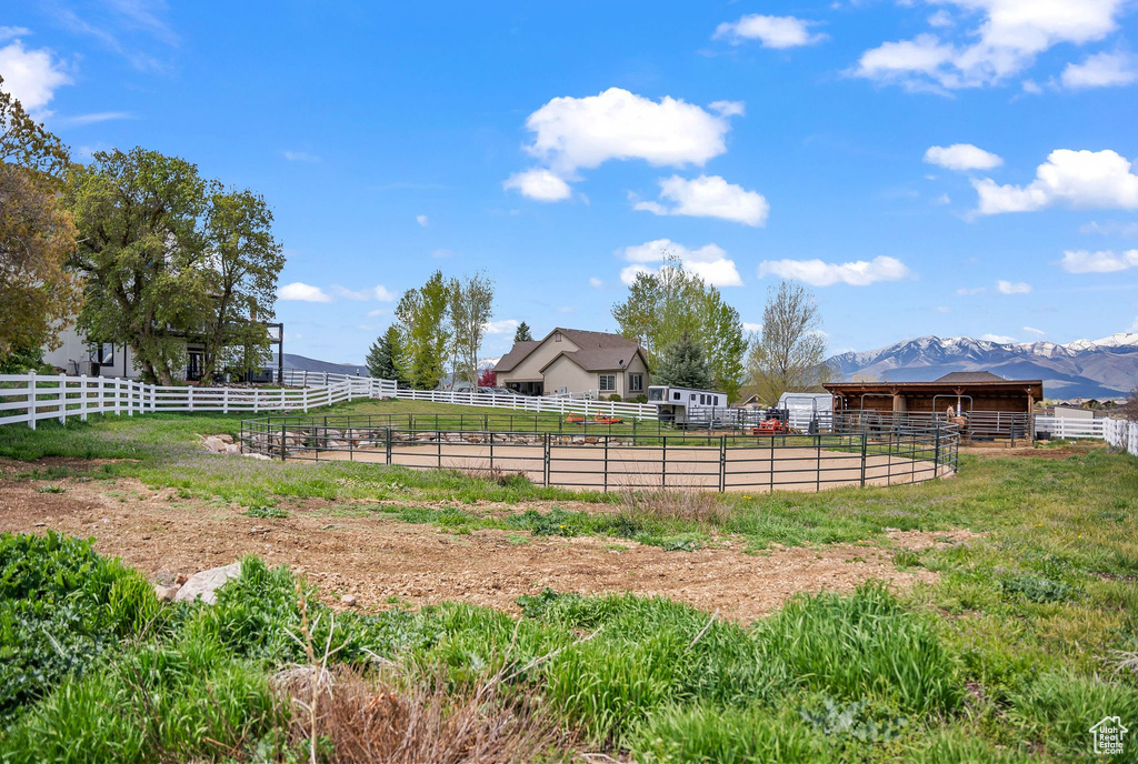 View of yard with a mountain view, an outdoor structure, and a rural view