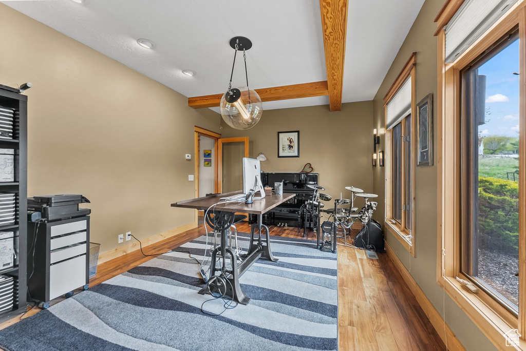 Interior space with beamed ceiling and wood-type flooring