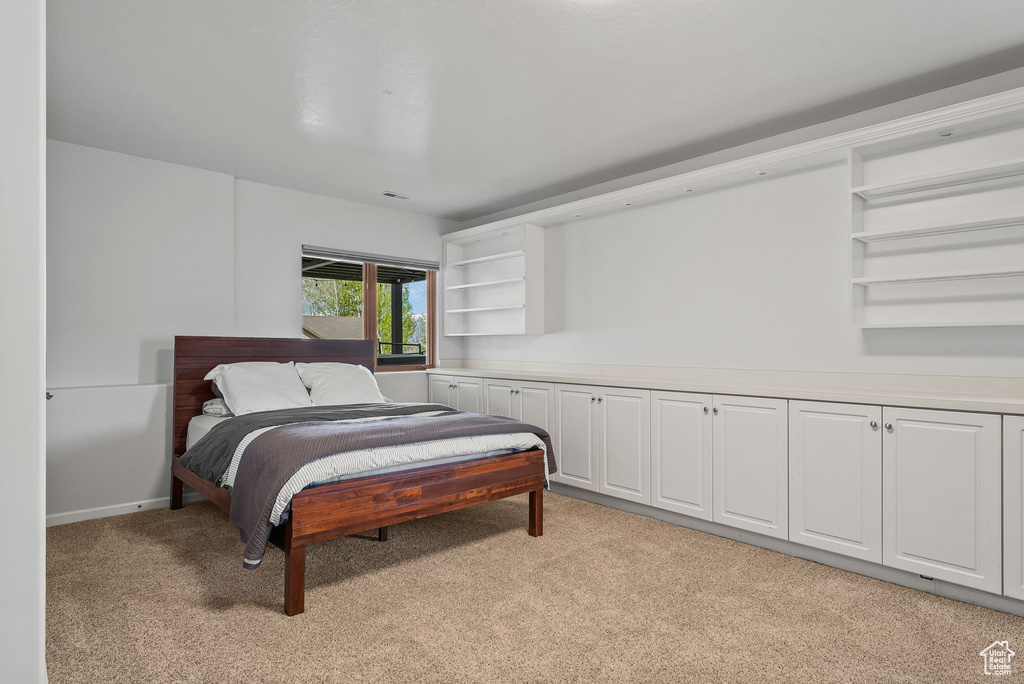 Bedroom featuring light carpet