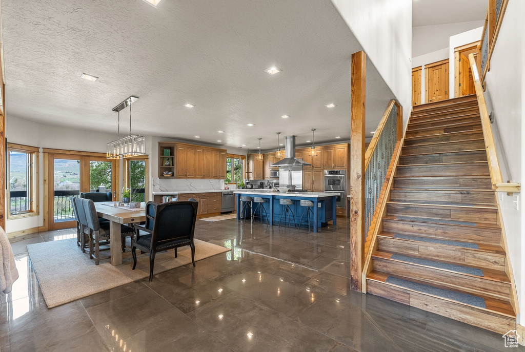 Tiled dining area with a notable chandelier and a textured ceiling