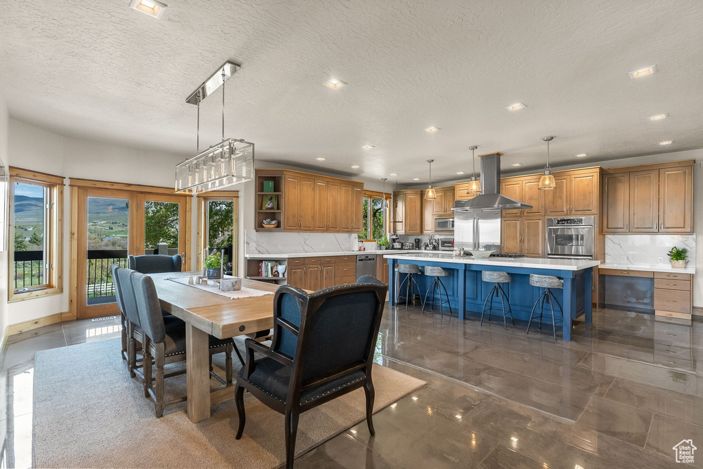 Dining room with tile flooring and a textured ceiling