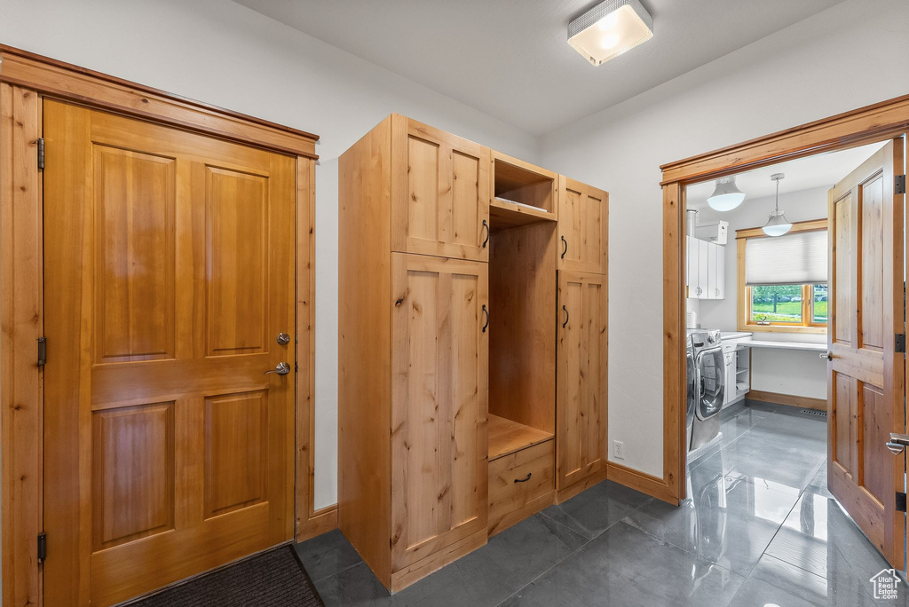 Mudroom with dark tile floors