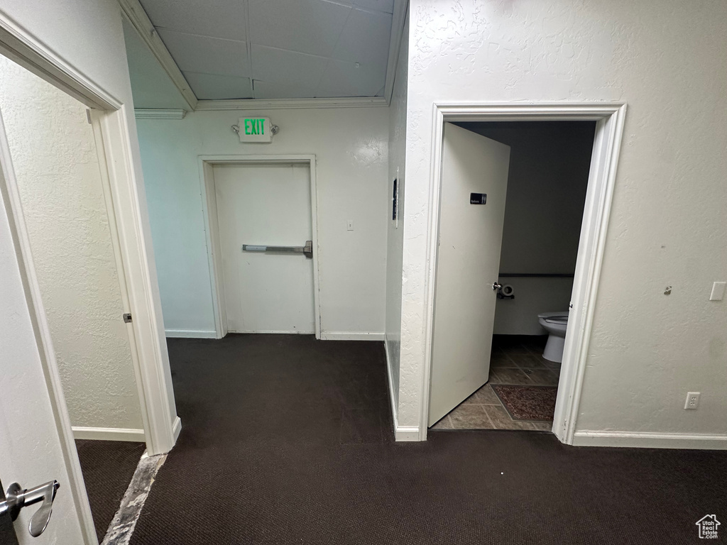 Corridor featuring dark tile floors