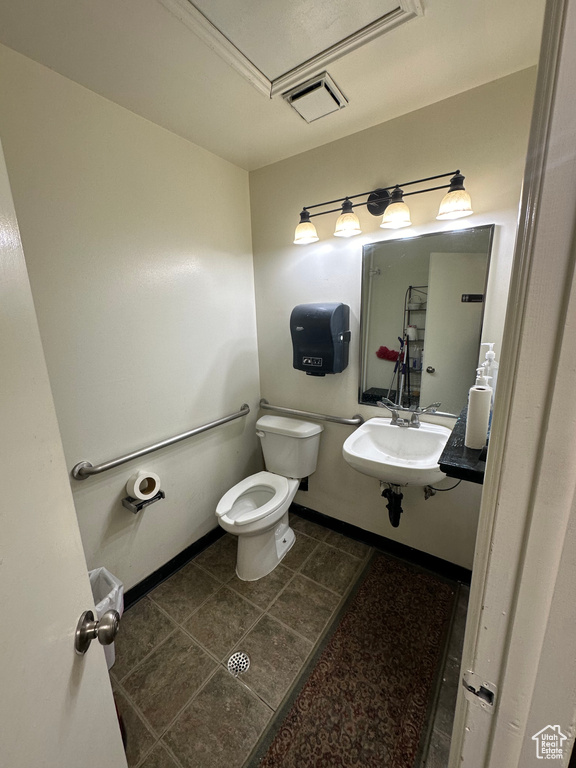 Bathroom with tile flooring, sink, and toilet