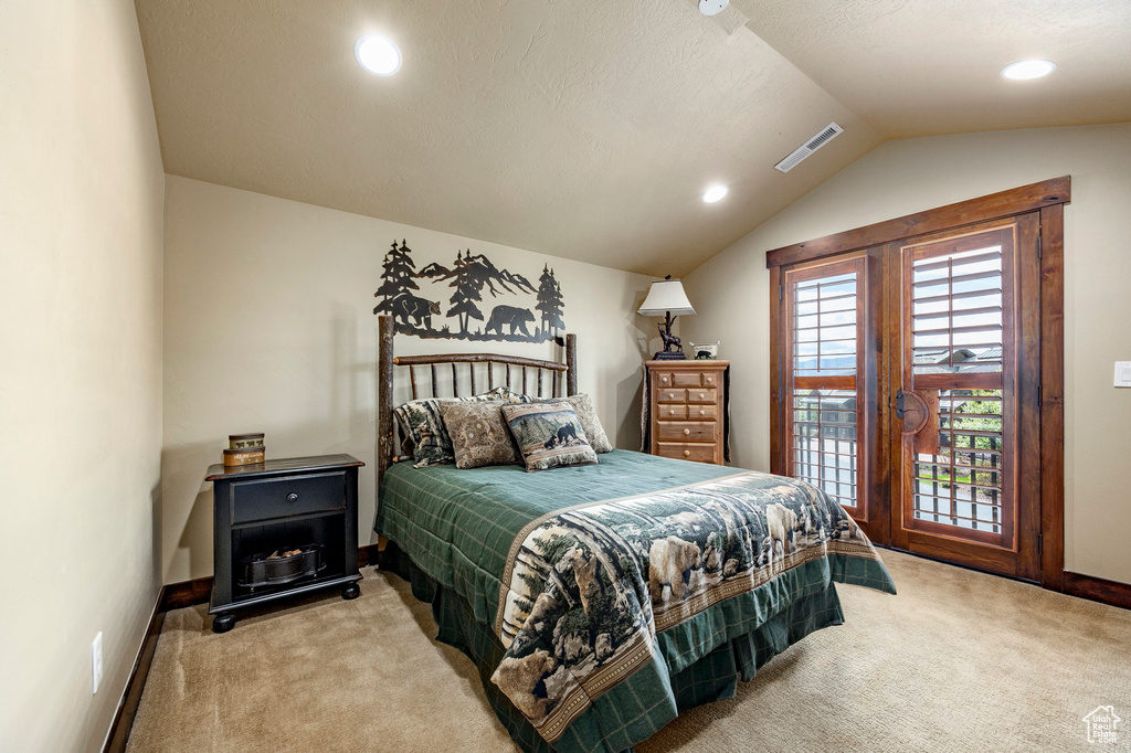 Bedroom featuring lofted ceiling and carpet floors