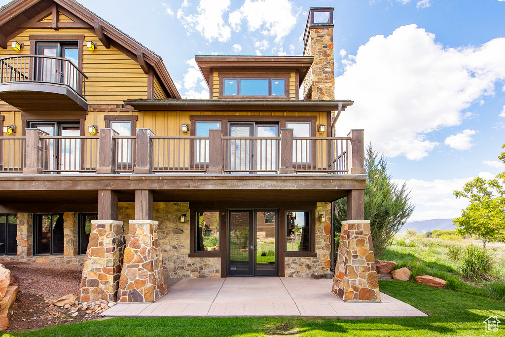 Back of property with a patio area and a balcony