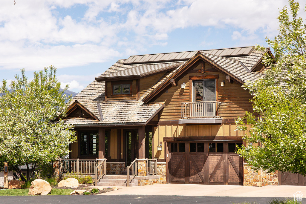 View of front of property with a garage and a balcony