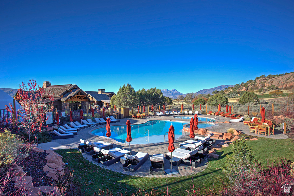 View of swimming pool with a mountain view and a patio area