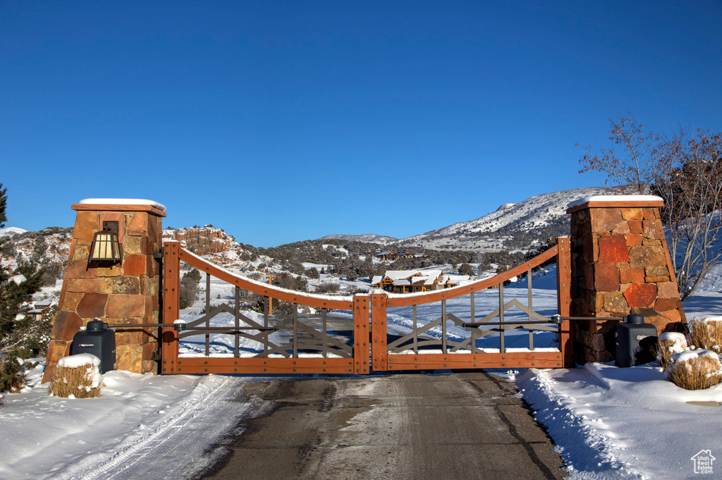 Snow covered gate with a mountain view