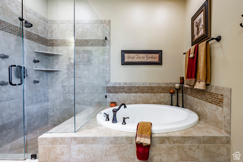 Bathroom featuring shower with separate bathtub and toilet